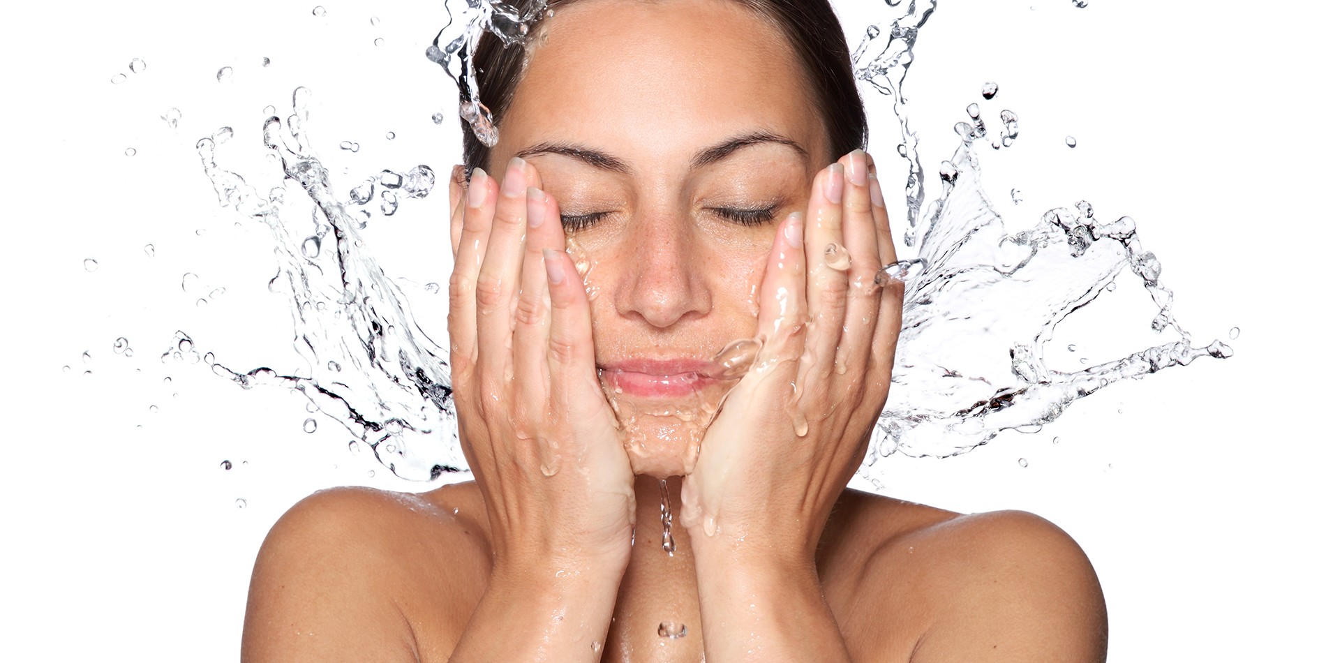 Beautiful wet woman face with water drop. Close-up portrait on white background