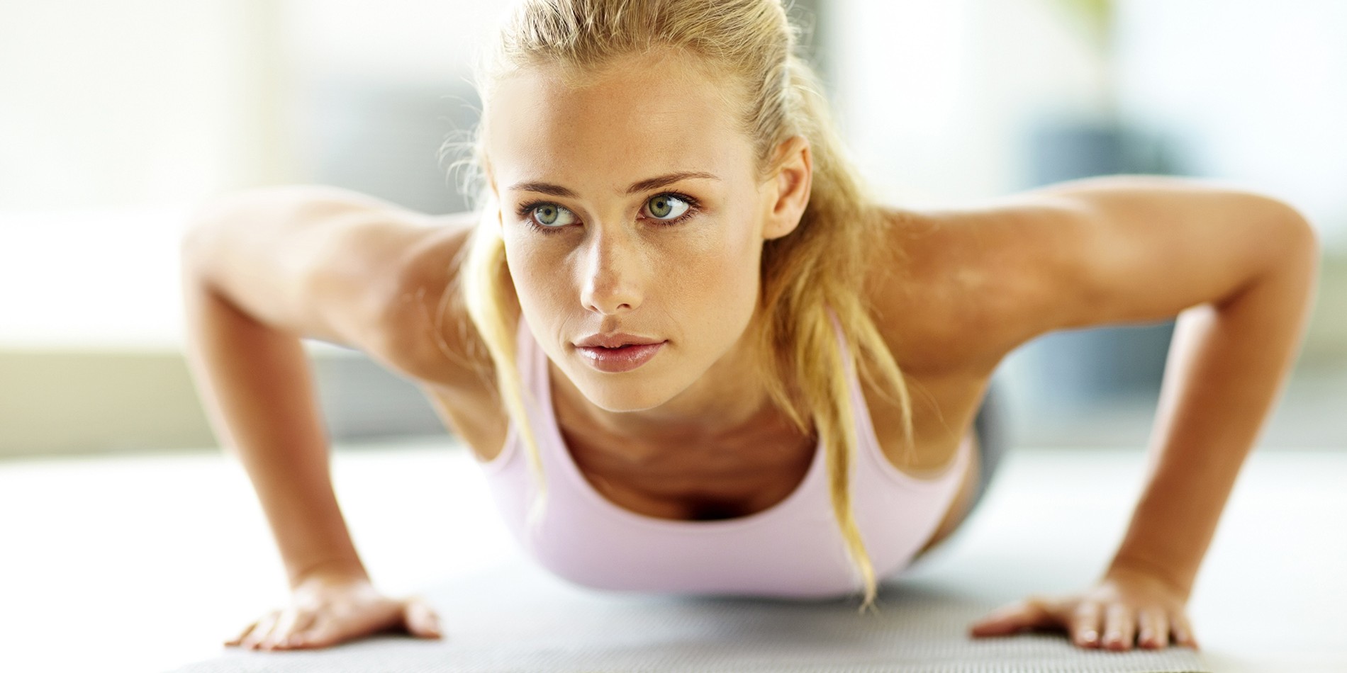Portrait of an attractive young female doing push up exercise