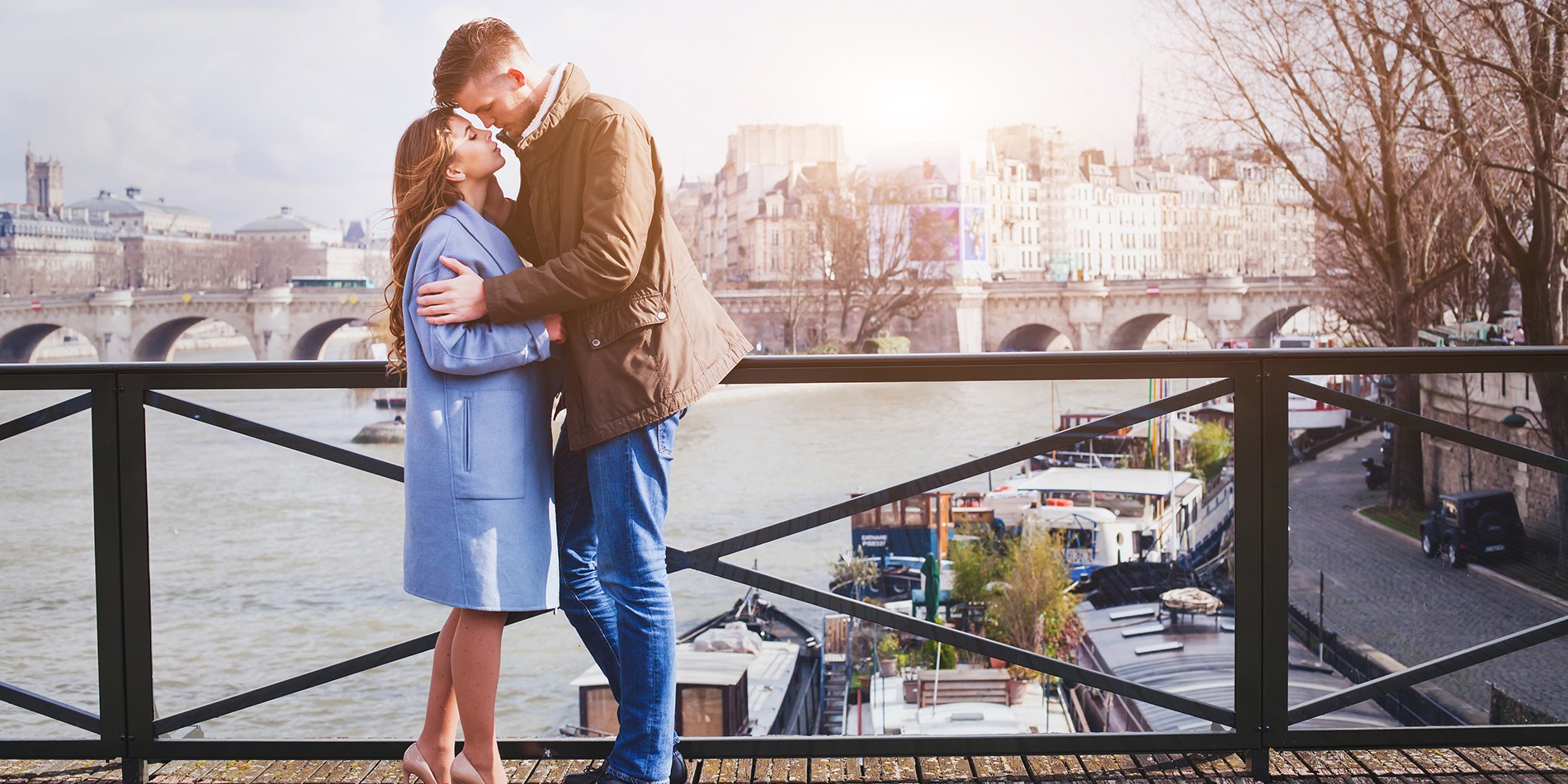 romantic date, young couple kissing on the bridge in Paris